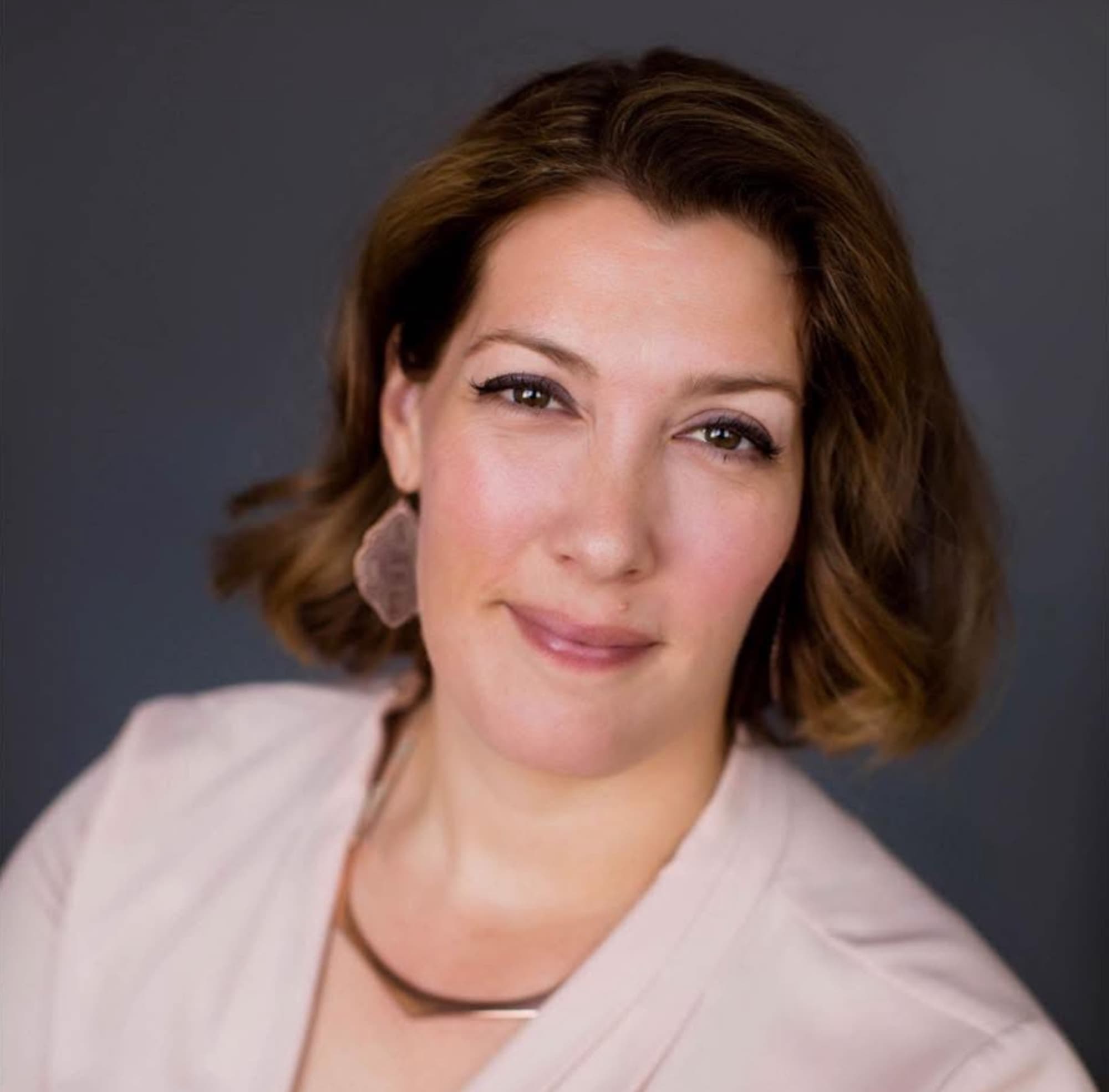 Professional portrait of Dr. Juliet O'Donnell, chiropractor in Urbandale, Iowa, smiling warmly.